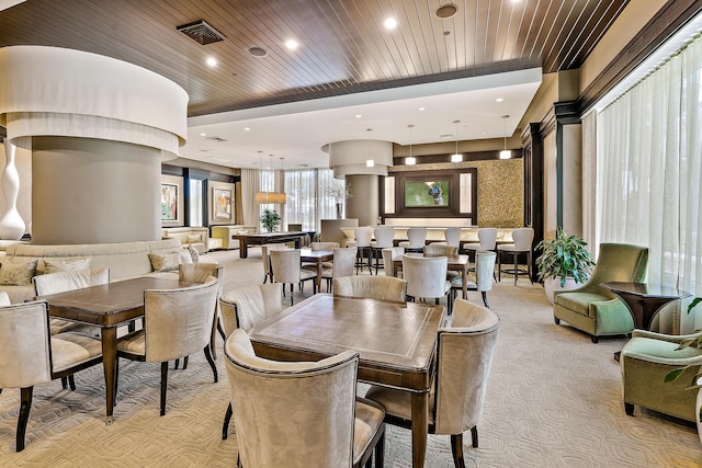 carpeted dining space with wood ceiling