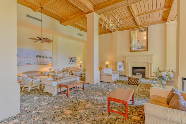 living room with beam ceiling, ceiling fan with notable chandelier, carpet floors, and wood ceiling