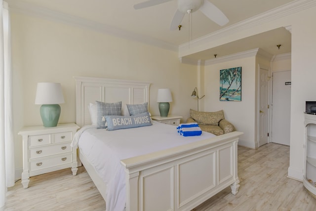 bedroom featuring ceiling fan, light wood-type flooring, and crown molding