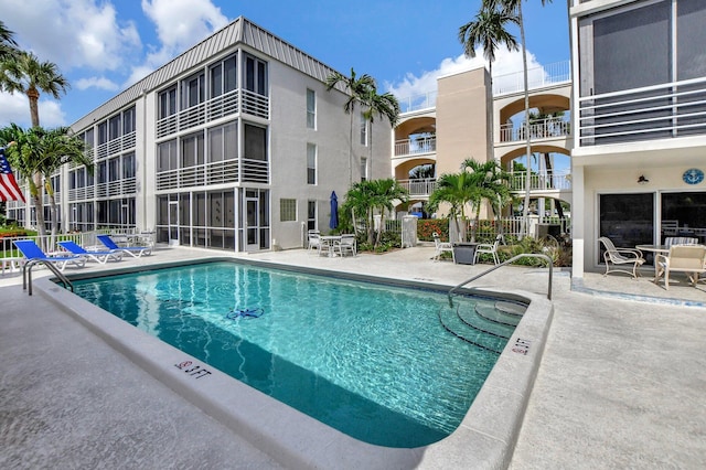 view of swimming pool with a patio