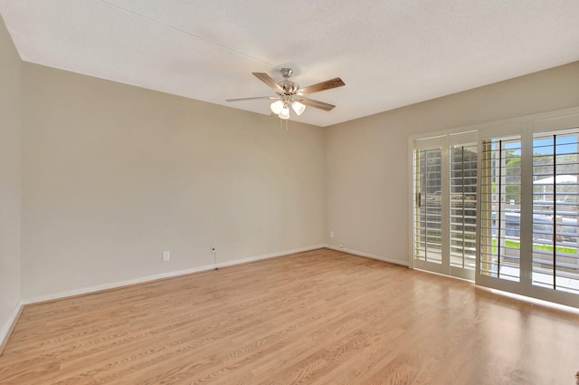 empty room featuring a textured ceiling, ceiling fan, and light hardwood / wood-style flooring