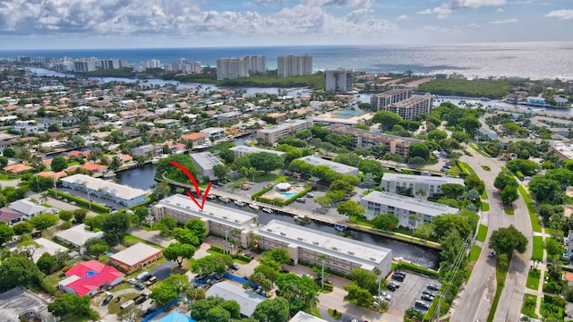 birds eye view of property with a water view