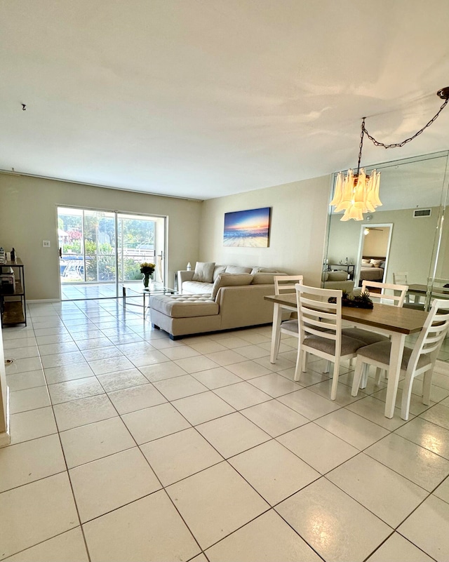 living room featuring light tile patterned floors and a chandelier