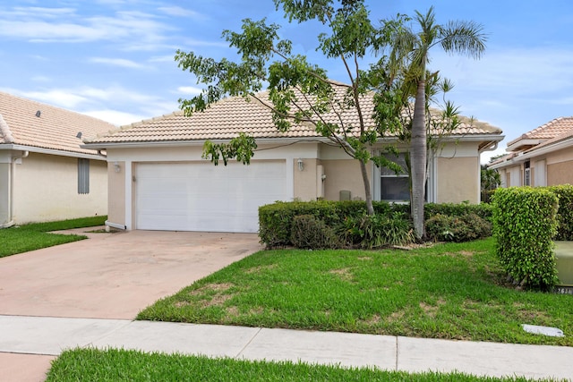 view of front of house featuring a garage and a front lawn