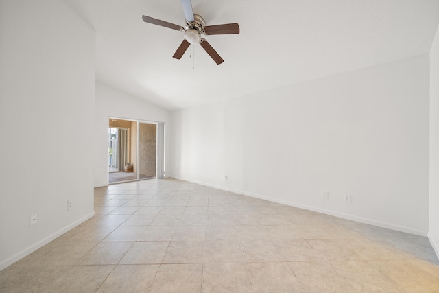 spare room with ceiling fan, light tile patterned flooring, and vaulted ceiling