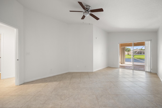 tiled empty room with ceiling fan and lofted ceiling