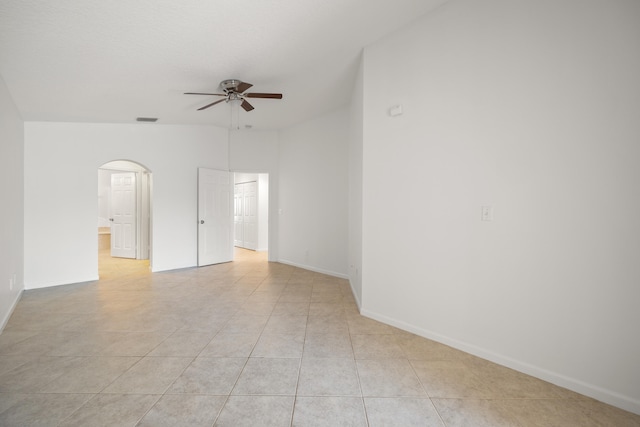 tiled empty room featuring ceiling fan