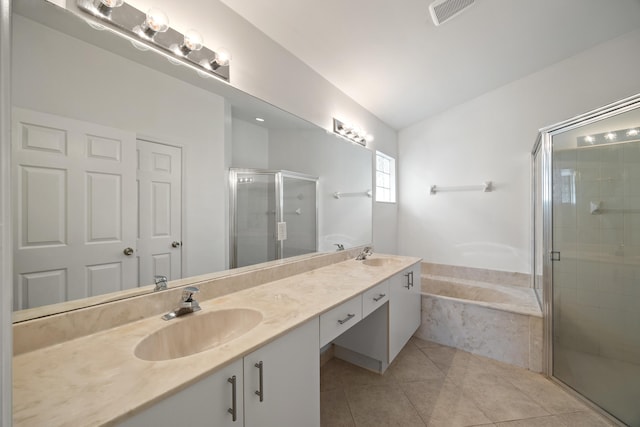 bathroom with tile patterned floors, vanity, and independent shower and bath