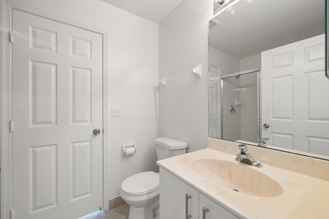 bathroom with tile patterned floors, vanity, toilet, and an enclosed shower