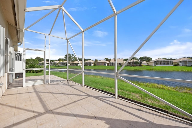 unfurnished sunroom with a water view