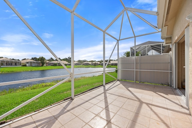 unfurnished sunroom featuring a water view