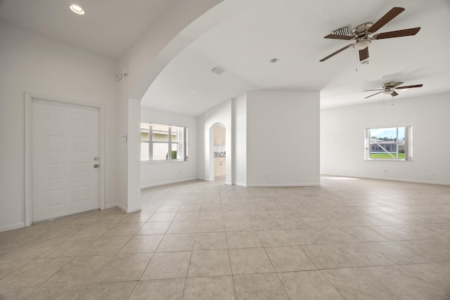 tiled spare room featuring ceiling fan