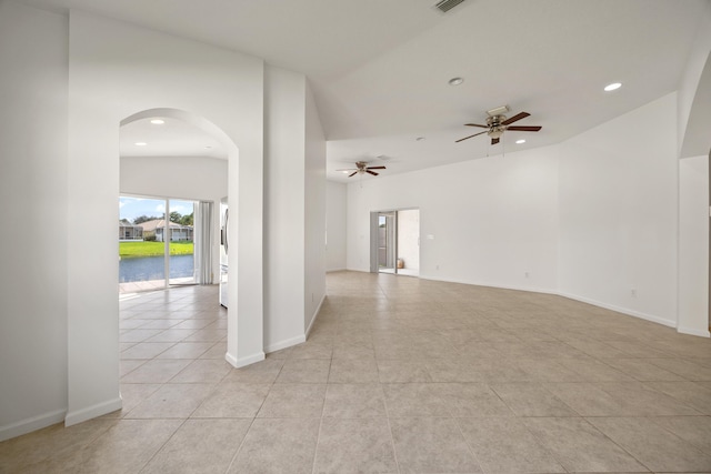 tiled spare room featuring ceiling fan and vaulted ceiling