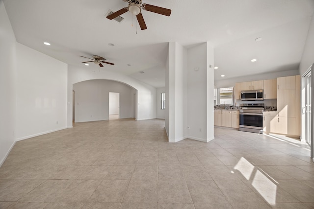 unfurnished living room with ceiling fan, light tile patterned flooring, and lofted ceiling