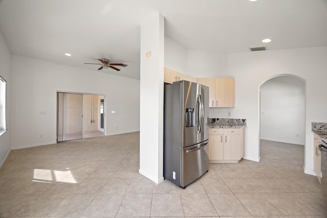 kitchen with ceiling fan, stainless steel fridge, light tile patterned flooring, and light brown cabinetry