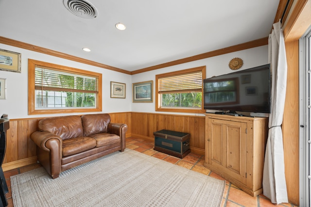 living room featuring ornamental molding and light tile flooring