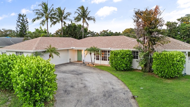 ranch-style house with a front lawn and a garage