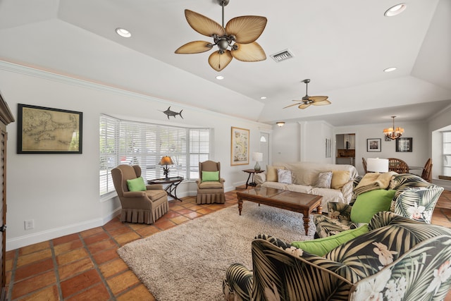 tiled living room featuring lofted ceiling and ceiling fan with notable chandelier