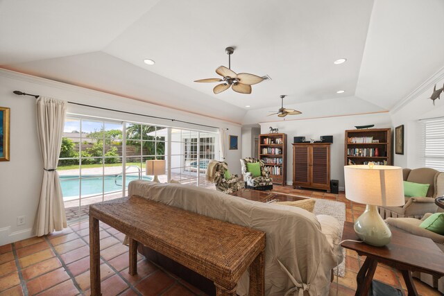 tiled living room with ceiling fan and vaulted ceiling