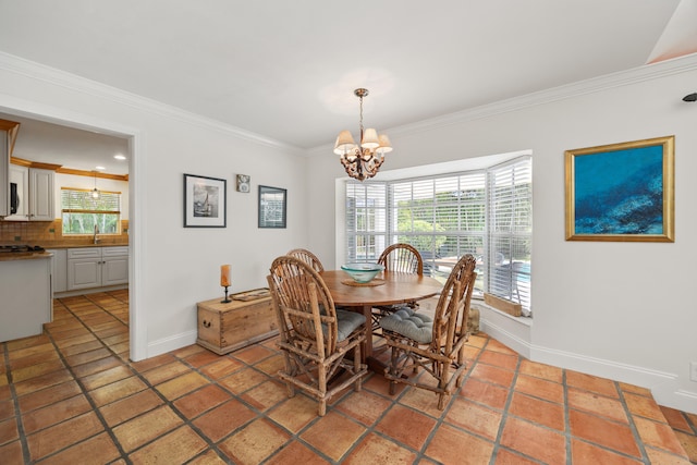 tiled dining room featuring a notable chandelier, ornamental molding, and sink