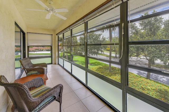 sunroom / solarium featuring ceiling fan