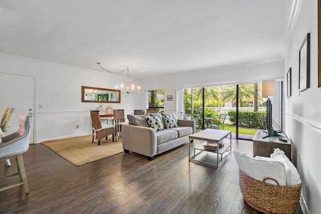 living room with dark hardwood / wood-style floors, an inviting chandelier, and crown molding