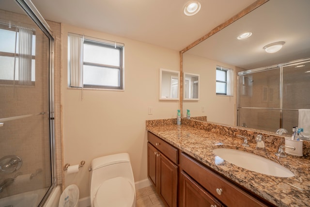 bathroom with vanity, toilet, and a shower with shower door