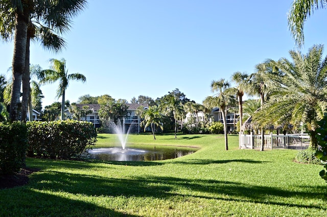 view of community featuring a water view and a yard