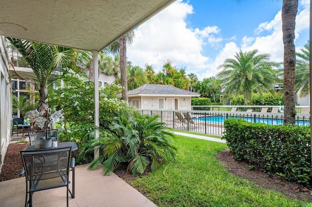 view of yard with a fenced in pool and a patio