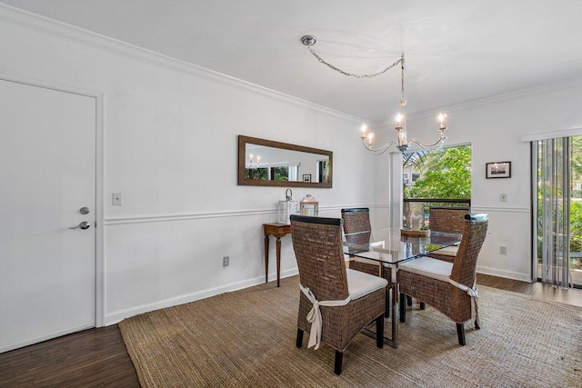 dining room featuring ornamental molding, dark wood-type flooring, and a chandelier