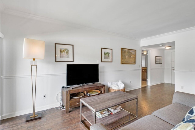 living room with dark hardwood / wood-style flooring and ornamental molding