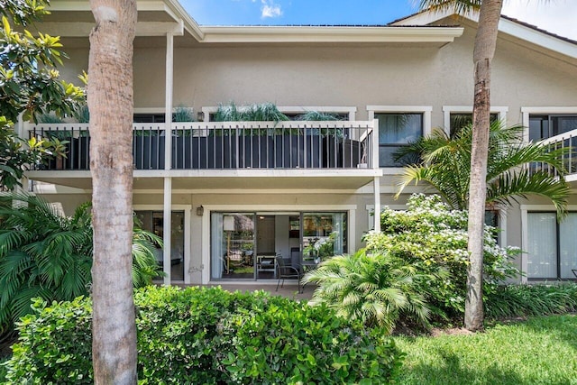 rear view of property featuring a balcony