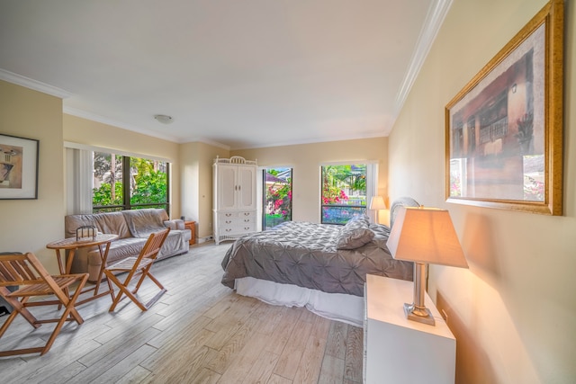 bedroom featuring multiple windows, crown molding, and light hardwood / wood-style flooring