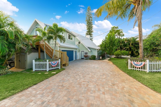 view of front of house featuring a front yard and a garage