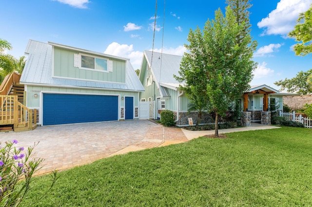 view of front of property featuring a garage and a front yard