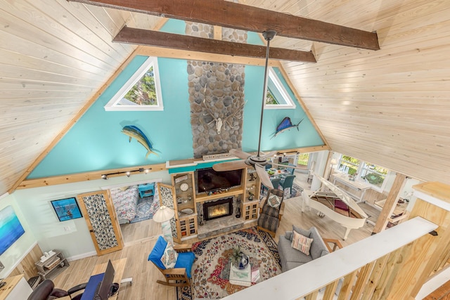 living room with wooden ceiling and vaulted ceiling with beams