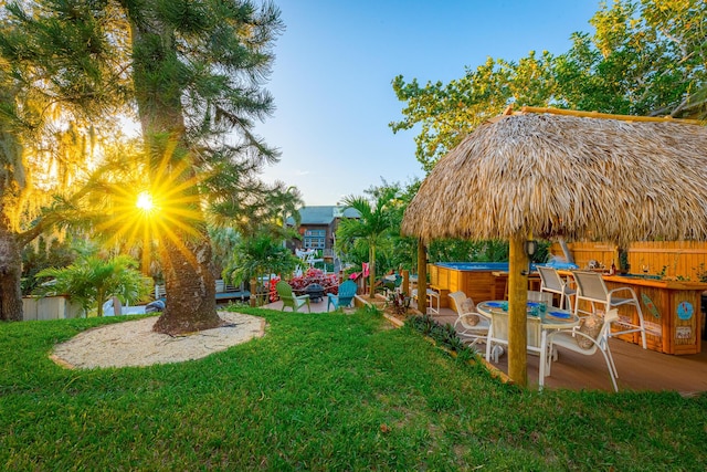 view of yard featuring a bar, a jacuzzi, and a patio area