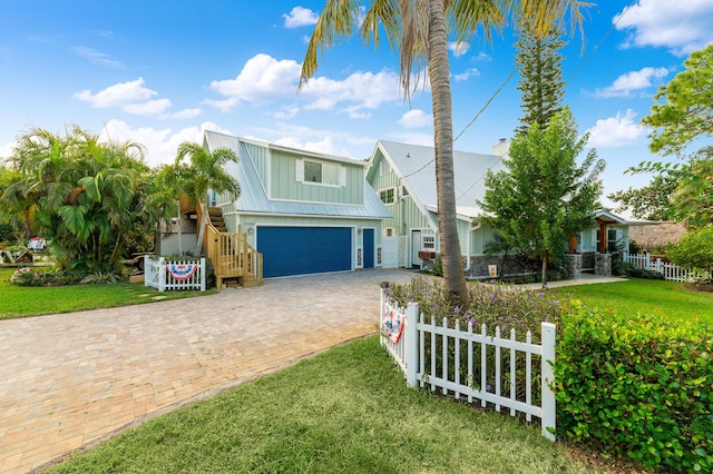 view of front of home with a front lawn and a garage