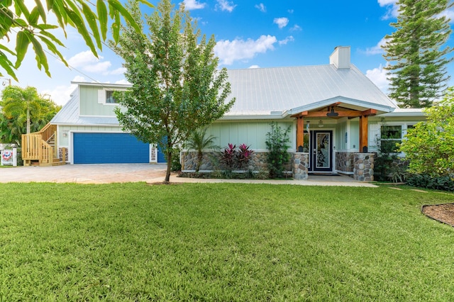 view of front facade with a garage and a front lawn