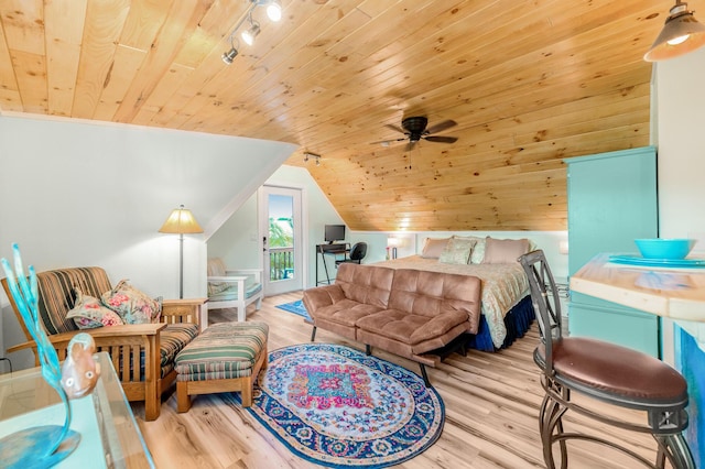 bedroom with light hardwood / wood-style floors, wooden ceiling, access to outside, track lighting, and lofted ceiling