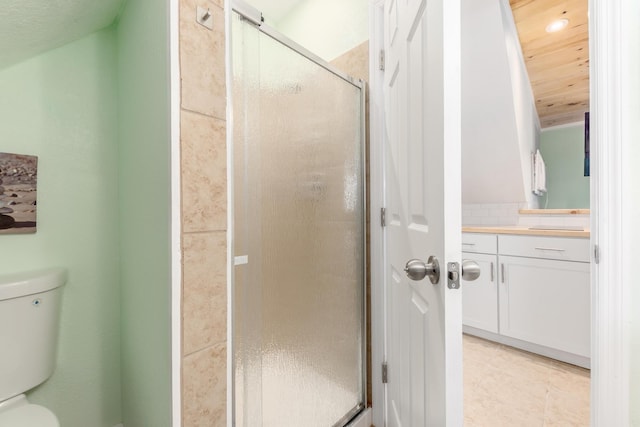 bathroom featuring toilet, wooden ceiling, and a shower with door