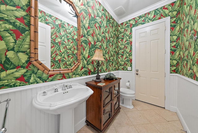 bathroom with toilet, tile patterned flooring, and ornamental molding