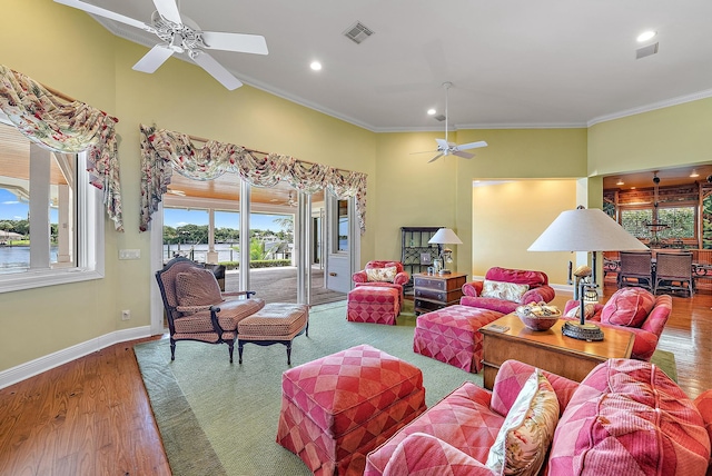 living room featuring hardwood / wood-style floors, ceiling fan, and ornamental molding