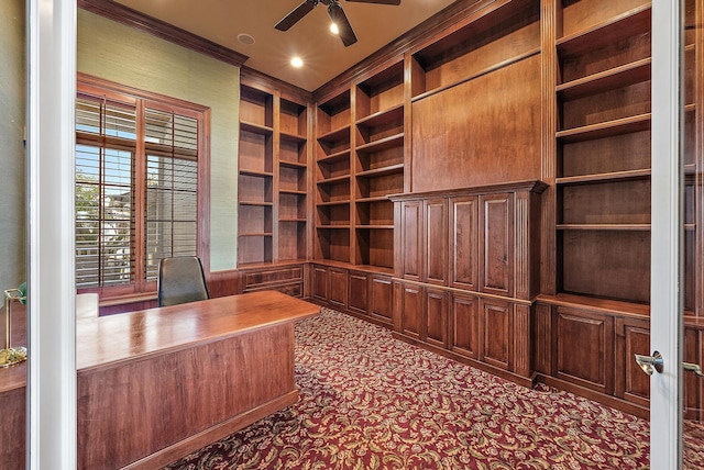 unfurnished office featuring ceiling fan and built in shelves