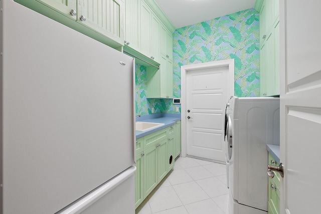 laundry area with sink, light tile patterned flooring, cabinets, and washer / dryer