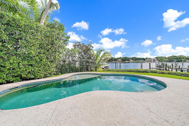 view of swimming pool featuring a water view