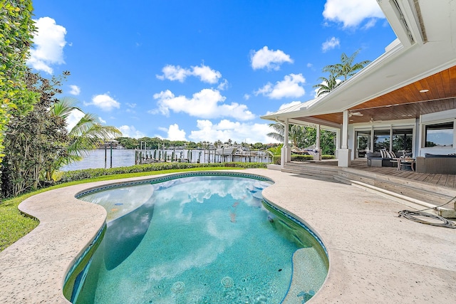 view of swimming pool featuring a patio and a water view