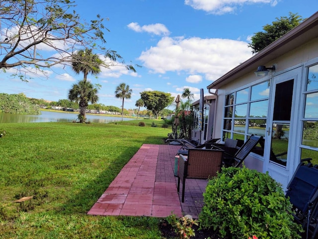 view of yard featuring a patio and a water view