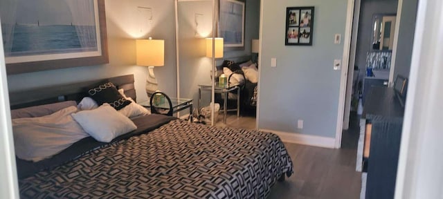 bedroom with dark wood-type flooring