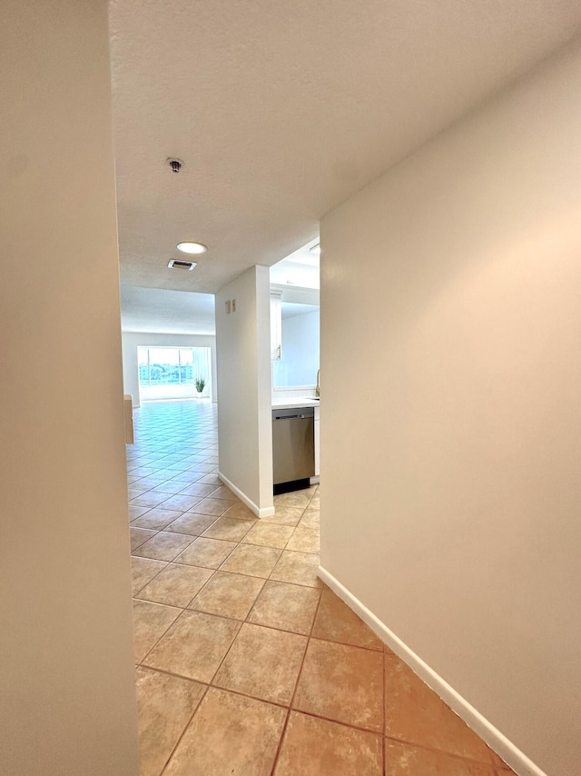 hallway featuring light tile patterned flooring